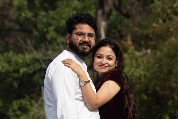 istock Happy couple in Rishikesh, hugging amid beautiful scenery, smiles at the camera with lush trees in the background 2075568502