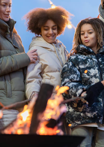 istock A happy family around a fire making marchmellows 2075569571