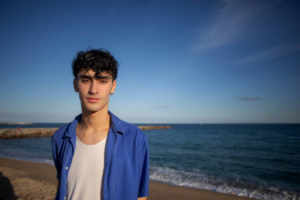 istock Portrait of young man on the beach 2075571174