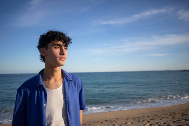istock Portrait of young man on the beach 2075571692