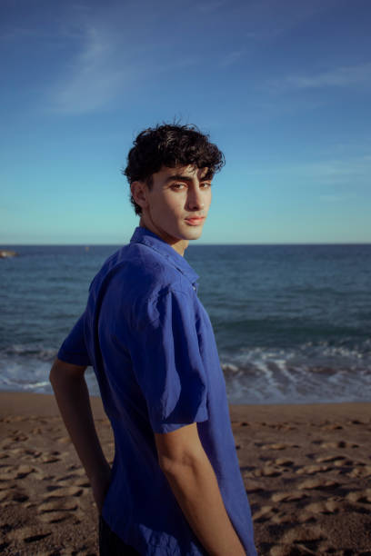 istock Portrait of young man on the beach 2075575352