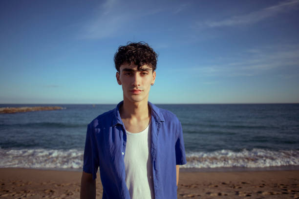 istock Portrait of young man on the beach 2075575353