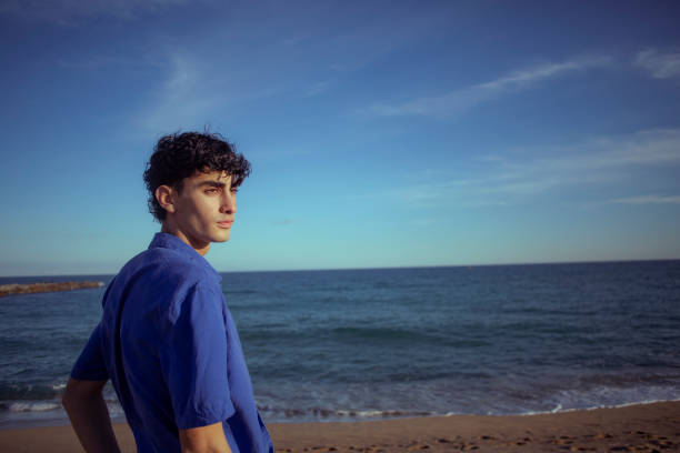 istock Portrait of young man on the beach 2075576931