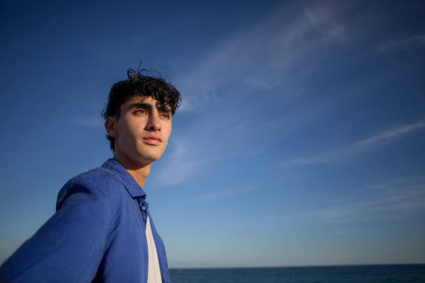 istock Portrait of young man on the beach 2075582684