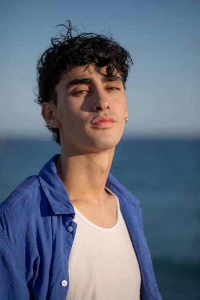 istock Portrait of young man on the beach 2075584789