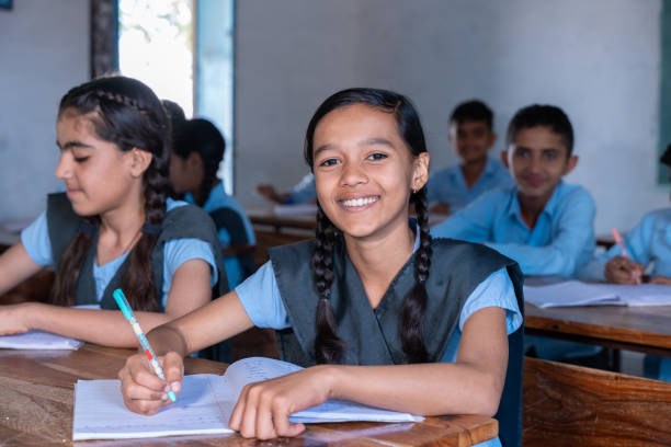istock Group of indian village students in school uniform sitting in classroom studying. Selective Focus, Education concept 2075586362