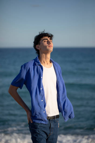 istock Portrait of young man on the beach 2075589323