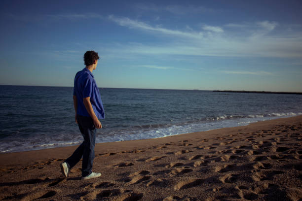 istock Portrait of young man on the beach 2075592272