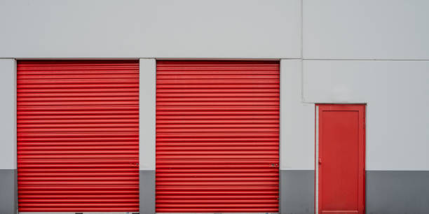 istock Symmetrical red garage doors of a storage facility. 2075592835