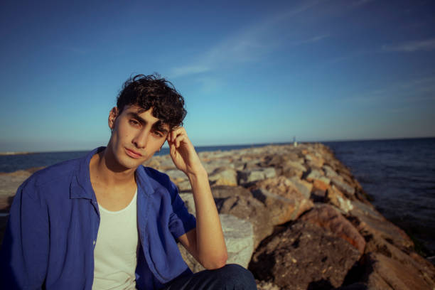 istock Portrait of young man on the beach 2075602114