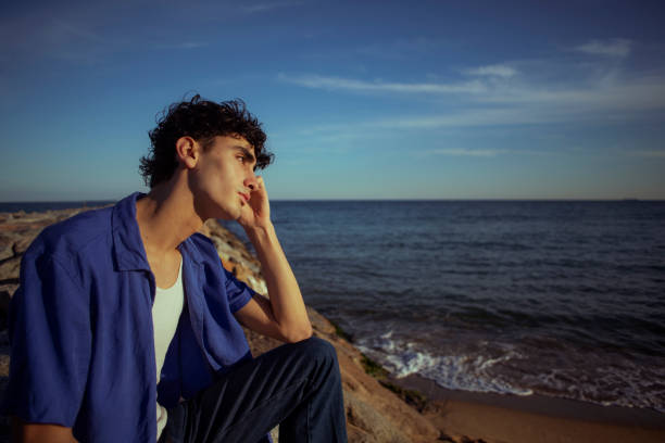 istock Portrait of young man on the beach 2075604203