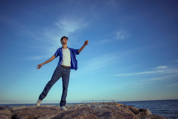 istock Portrait of young man on the beach 2075621599