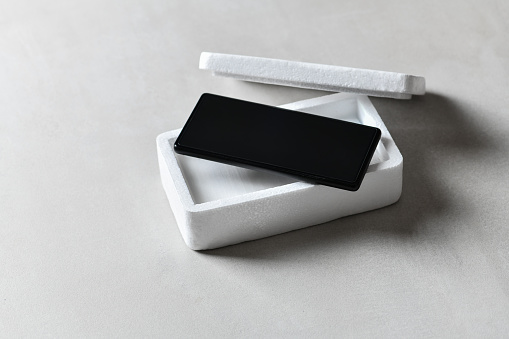 A Perfect Depiction Of Styrofoam Protective Box And Smartphone