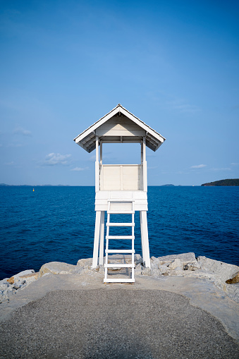 lifeguard tower on the beach against blue sky