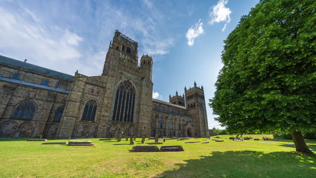 Panoramic scene of Durham Cathedral with blue sky and clouds in North East England, UK - 4k time lapse