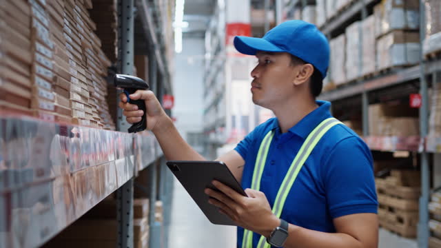 Warehouse workers use digital tablet with scanners to check and scan the barcode of stock inventory to keep storage in a system.