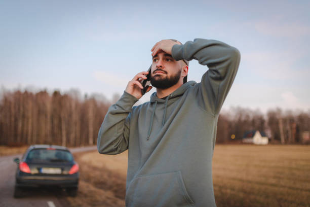 istock Stressed man calling for help while being stranded on the side of the road 2075689817