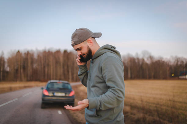 istock Stressed man calling for help while being stranded on the side of the road 2075689827