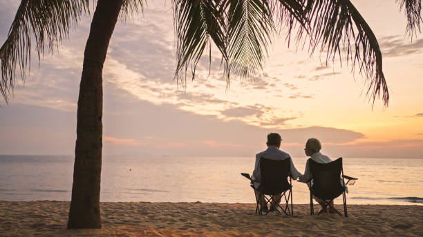 istock Senior couple relaxing on the beach chairs at sunset. 2075691963