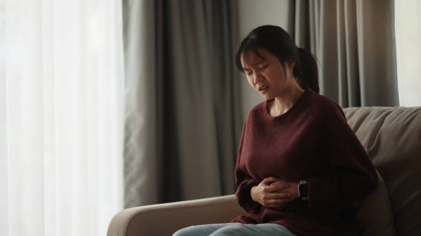 istock Girl experiencing stomach pain. 2075702620