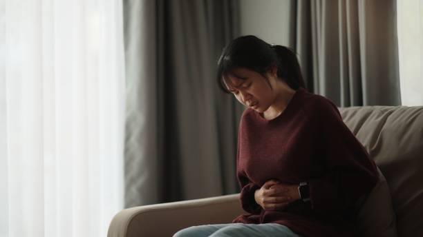 istock Girl experiencing stomach pain. 2075702624
