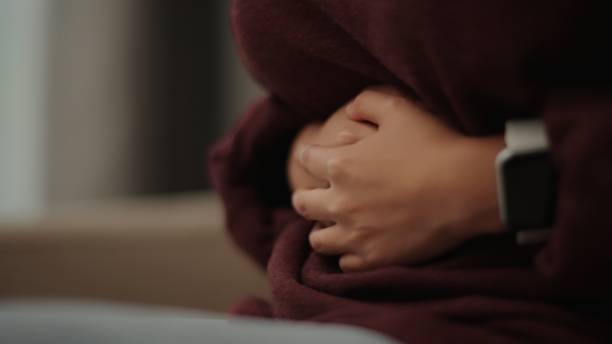 istock Girl experiencing stomach pain. 2075702634