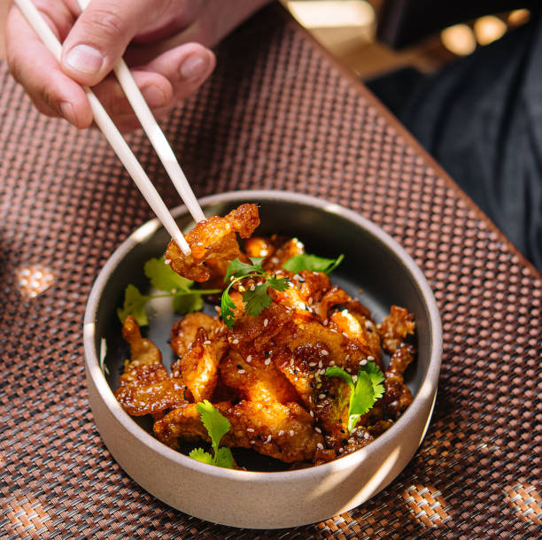 istock man eating with chopsticks gourmet fried squid Yakuza 2075730004