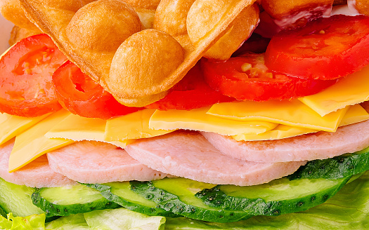 Belgian waffles with ham, cheese and salad close up