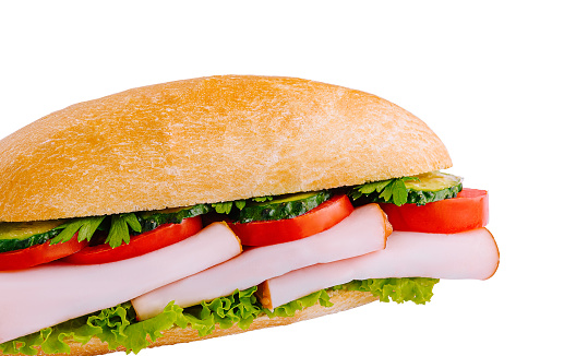 Salami sandwich made from bun, sliced ham and fresh letttuce, tomato and cheese. Healthy breakfast. Copy space