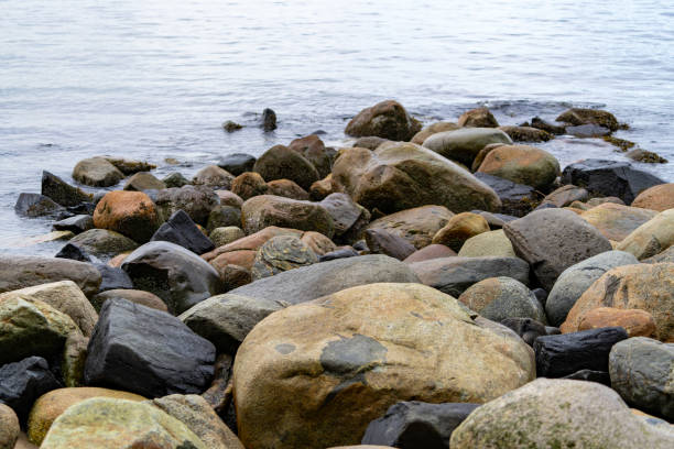 The sea hits the rocks on the beach.
