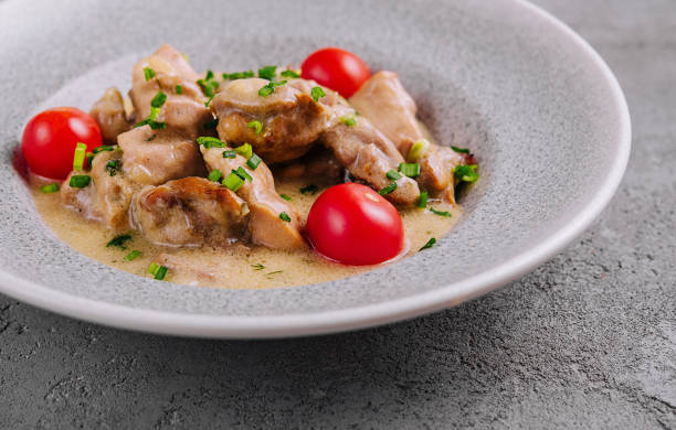 istock Grilled chicken breast with cream sauce and tomatoes 2075741909