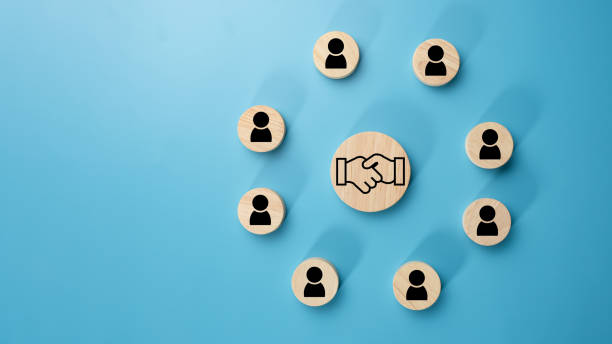 istock Team management concept, Human resources, Recruitment concept, HRM administration or human resource management concept, The handshake icon in a circular wooden board placed on a light blue background. 2075742037