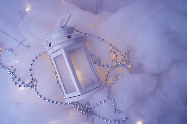 White lantern on and Christmas garland