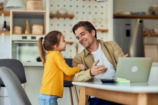 istock A dad working from home, online while her daughter wants to play with him. 2075743082