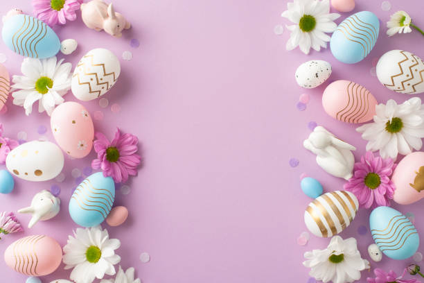 istock Elegant Easter display concept: top view featuring decorated eggs, ceramic hares, chamomiles, and confetti on a gentle purple backdrop, designed with space for warm wishes or advertising content 2075743417