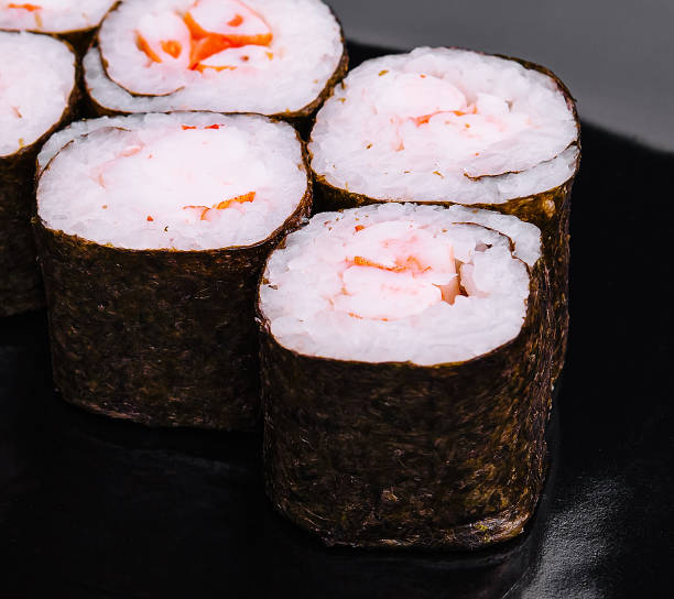 istock sushi roll maki with shrimp on a black plate 2075751948