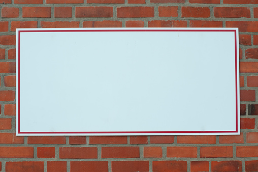 Empty rectangular white sign on the wall