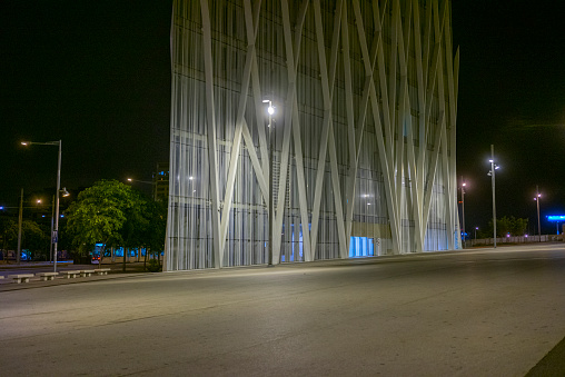 This picture shows the modern architecture Barcelona at night in the summer of August 2014. You can see an open space and a modern office building in the background.