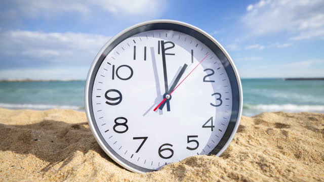 a large clock on beach