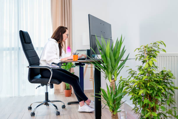 istock business woman sit indoors in  office using laptop computer 2075831669