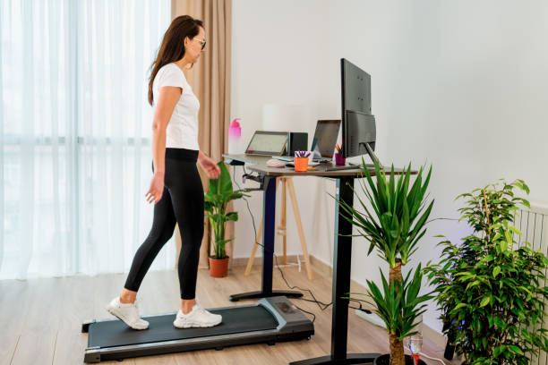 istock Woman at home office is walking on under desk treadmill 2075832754
