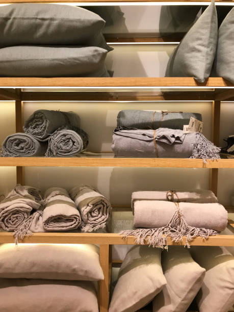 istock Linen or knitted plaids rolled up on a shop window 2075839567