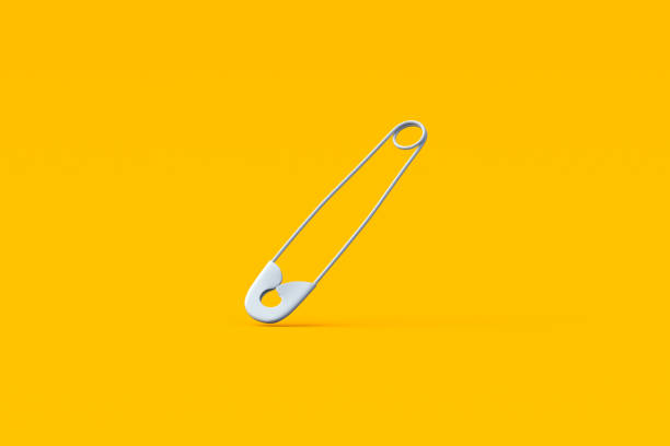 istock Falling safety pin on yellow background. Tool for sewing. 3d render 2075842353