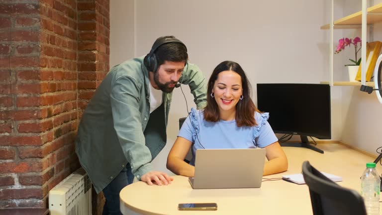 Man and woman working together in a small customer service office