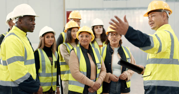 istock Construction site, teamwork and people in presentation for planning, meeting and discussion in building. Architecture, engineering and men and women for inspection, property development and project 2075853769