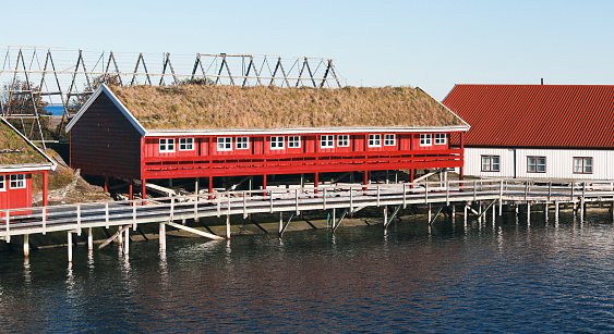 Coastal Norwegian red wooden barns on a rocky island. Ringholmen panoramic view, Norway