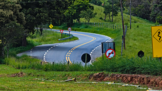 paved and well-signposted stretch of winding road in the countryside - CUNHA, SAO PAULO,  BRAZIL.