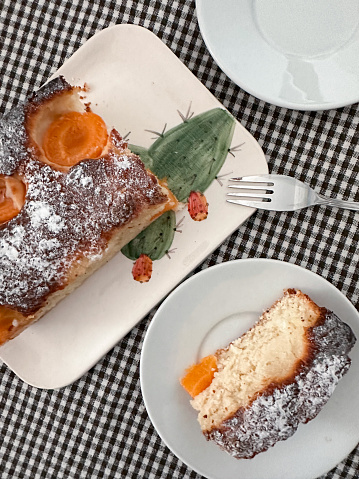 Table top view with homemade peach cake