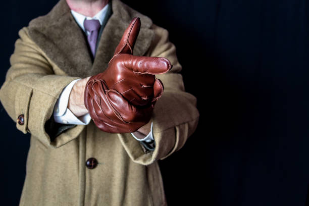 secret agent spy aiming hand like a gun - spy gun men humor imagens e fotografias de stock