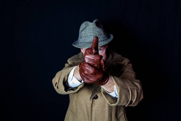 portrait of mafia type man with stern eyes and stubble. Shot in studio light with a full-frame camera.